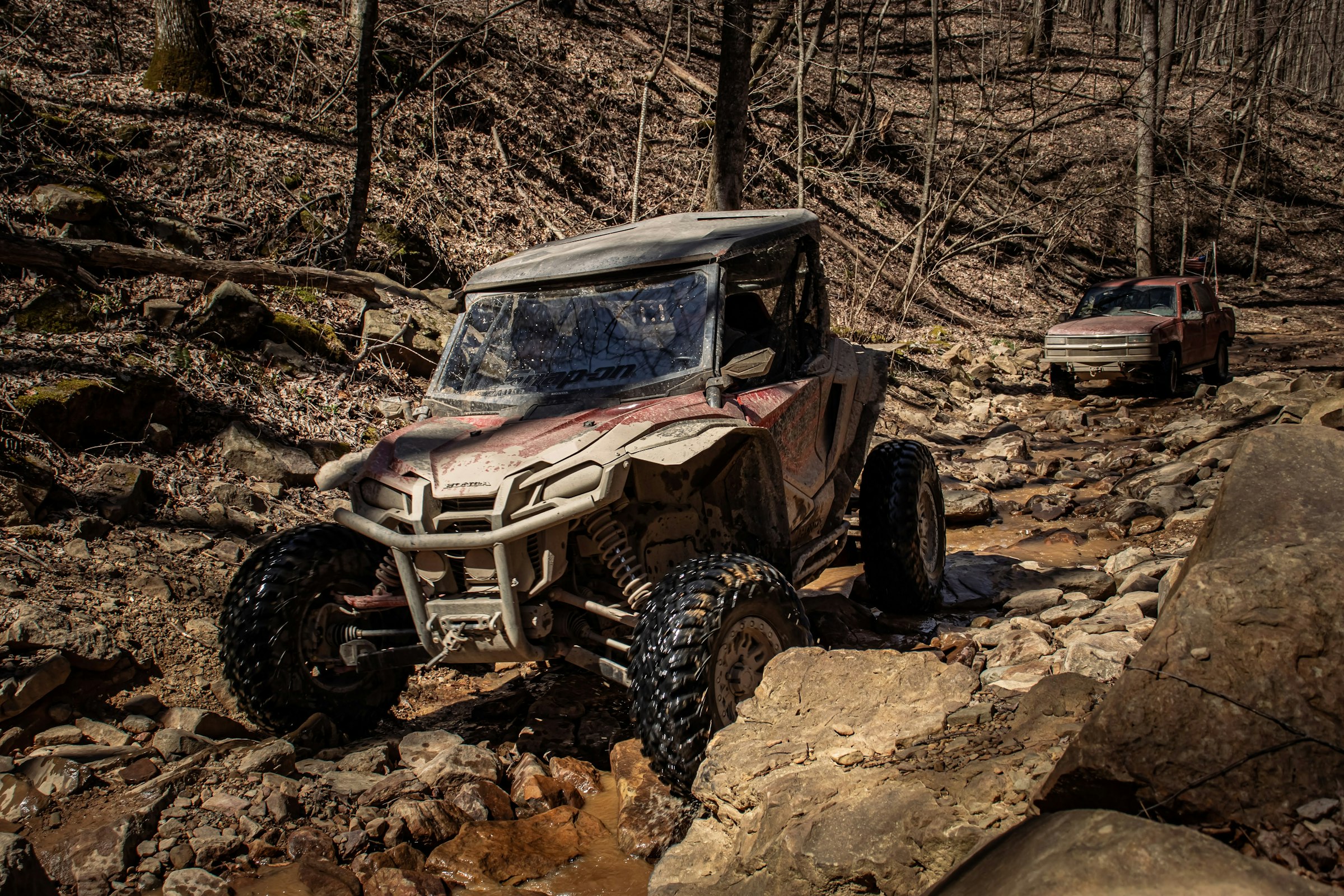 an off road vehicle driving on a rocky trail